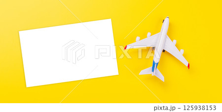 Travel-themed flat lay with blank photo card and toy airplane Travel-themed flat lay with blank photo card and toy airplane 125938153