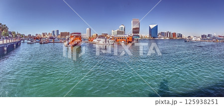 Boats floating on Dubai Creek with skyline in background Boats floating on Dubai Creek with skyline in background 125938251