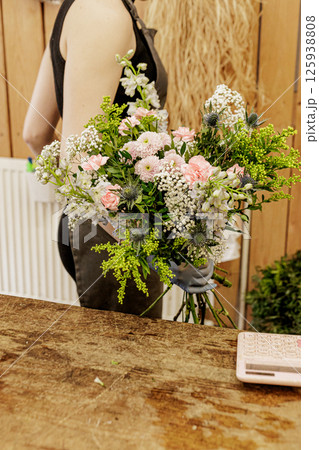 Florist arranging bouquet of pink and white flowers, Mothers day 125938808