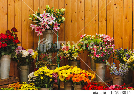 Colorful flower bouquets displayed on wooden steps in flower shop, Mothers day Colorful flower bouquets displayed on wooden steps in flower shop, Mothers day 125938814