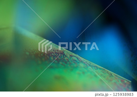 Green and blue liquid surface, green Reflections of liquid in macro,, bubbles in macro, connection of bubbles in macro, cell from liquid, dark background, glossy surface 125938983