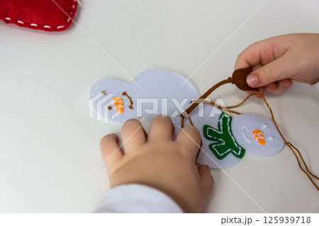 The hand of the child make snowman for christmas greeting card. Hobby concept. Handmade. 125939718