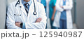 Attractive male doctor in front of medical group 125940987
