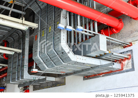 electrical steel pipeline, Electrical cable wire way on wall, cable routing between electrical distribution panel with equipment, industry construction concept background. 125941375