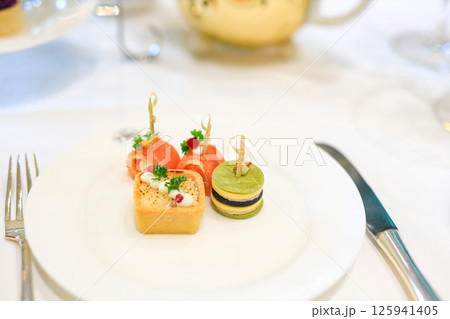 Dessert, cake, canape, macarons and sweets to accompany afternoon tea. Dessert, cake, canape, macarons and sweets to accompany afternoon tea. 125941405