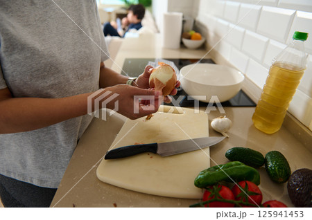 Person Preparing Vegetables and Ingredients in a Modern Kitchen Person Preparing Vegetables and Ingredients in a Modern Kitchen 125941453