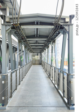 Pedestrian pathway or corridor or hallway between train station and other building. Pedestrian pathway or corridor or hallway between train station and other building. 125941643