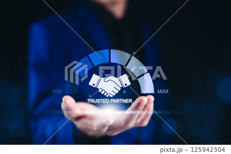 Trusted Partner and Business Collaboration Concept. Businessman holding glowing handshake icon with a trust level gauge, business partnership, reliability, and professional collaboration. trustworthy, 125942304