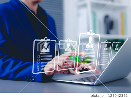 Recruitment and candidate selection concept. Businessman interacts with digital interface with multiple candidate profiles on laptop. Represents online recruitment, HR technology, hiring process, Recruitment and candidate selection concept. Businessman interacts with digital interface with multiple candidate profiles on laptop. Represents online recruitment, HR technology, hiring process, 125942351
