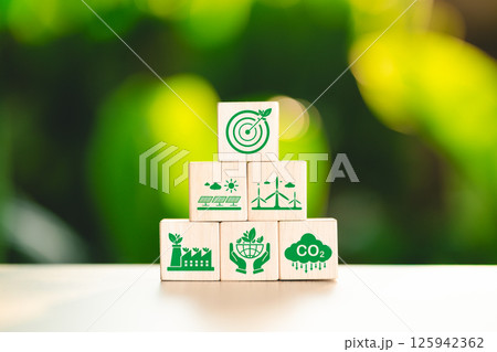Sustainable energy and environmental protection concept. Wooden block stacked displaying sustainability icon, renewable energy, eco-friendly industry, CO2 reduction, environment conservation, net zero 125942362