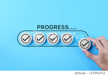 Checklist and task progress tracking concept. A hand placed the final checkmark on round wooden in progress bar, task completion, productivity, goal setting, efficient project management, loading bar, Checklist and task progress tracking concept. A hand placed the final checkmark on round wooden in progress bar, task completion, productivity, goal setting, efficient project management, loading bar, 125942412