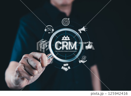 CRM System for Customer Relationship Management. A person interacts with CRM interface icons for support, analytics, marketing, and feedback, illustrating customer relationship management in business. 125942416
