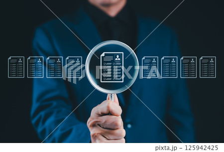 Resume Screening and Candidate Evaluation Concept. Businessman holding magnifying glass on resume icons, recruitment, candidate screening, human resources, employee evaluation, HR document analysis, Resume Screening and Candidate Evaluation Concept. Businessman holding magnifying glass on resume icons, recruitment, candidate screening, human resources, employee evaluation, HR document analysis, 125942425