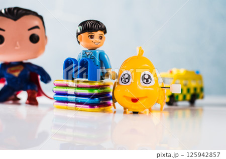 Plastic construction set for boy, yellow plastic fish, magnetic construction set parts, superhero figure and ambulance. 125942857