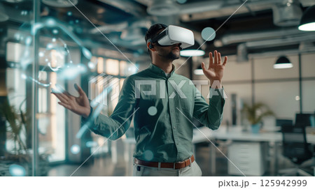 Business portrait corporate man in blue shirt, open office interactive holographic projections all around. wearing VR  125942999