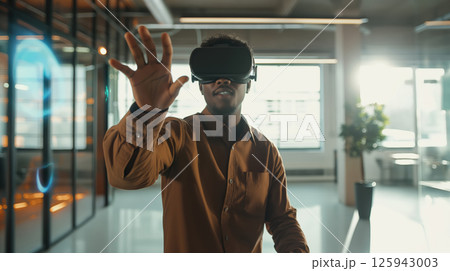 Business portrait corporate man in shirt, open office interactive holographic projections all around. wearing VR headset glasses 125943003