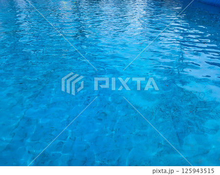 In the blue pool, the wind raised ripples on the surface of the water 125943515