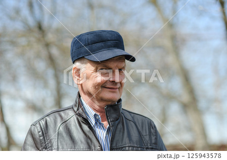 Gray-haired pensioner smiling beautifully. Strong elderly man on the street. 125943578