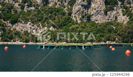 Aquaculture fish farm natural mountainous setting. Sustainable fishing seafood production concept Aquaculture fish farm natural mountainous setting. Sustainable fishing seafood production concept 125944298