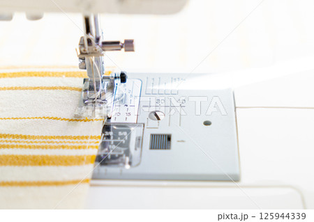 sewing machine with a cloth under a steel needle. manufacture of clothing. 125944339