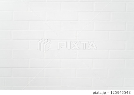 Clean white painted brick wall closeup with soft shadow detailing 125945548