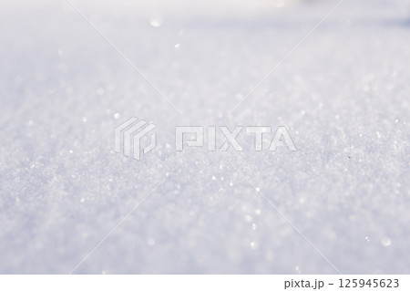 Sparkling fresh snow surface with soft light reflections and bright winter atmosphere Sparkling fresh snow surface with soft light reflections and bright winter atmosphere 125945623