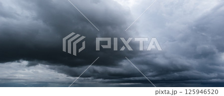 The dark sky filled with swirling clouds forebodes an approaching windstorm, showcasing the power of nature's forces and the dramatic shifts in weather during turbulent atmospheric conditions. The dark sky filled with swirling clouds forebodes an approaching windstorm, showcasing the power of nature's forces and the dramatic shifts in weather during turbulent atmospheric conditions. 125946520