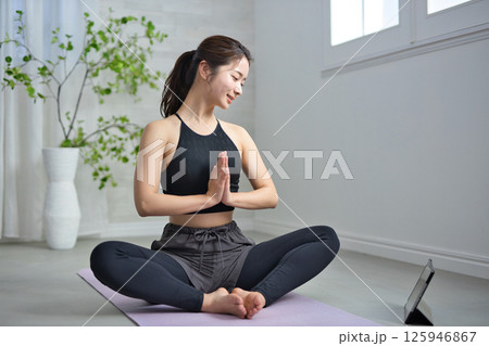 オンラインヨガを楽しむ20代の女性 125946867