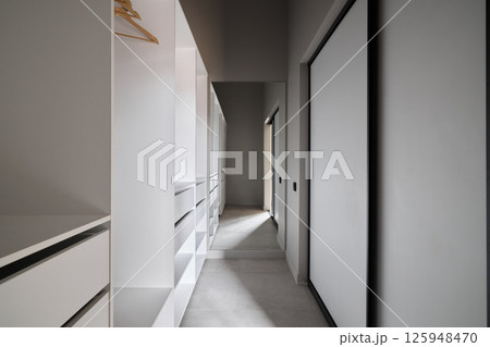 A Modern Minimalist Corridor with Stylish Storage Solutions for Optimal Organization A Modern Minimalist Corridor with Stylish Storage Solutions for Optimal Organization 125948470