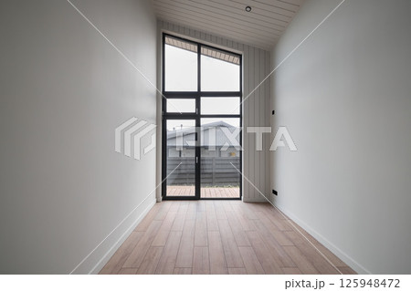 A Minimalist Modern Room that Features Large Windows Allowing in Abundant Natural Light A Minimalist Modern Room that Features Large Windows Allowing in Abundant Natural Light 125948472
