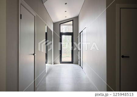 A Stunning Modern Hallway Featuring Large Windows and a Contemporary Minimalist Design 125948513