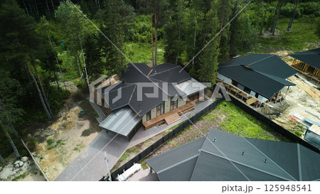A Stunning Aerial View of Contemporary Modern Homes Nestled in a Lush Tree Surrounding Area A Stunning Aerial View of Contemporary Modern Homes Nestled in a Lush Tree Surrounding Area 125948541