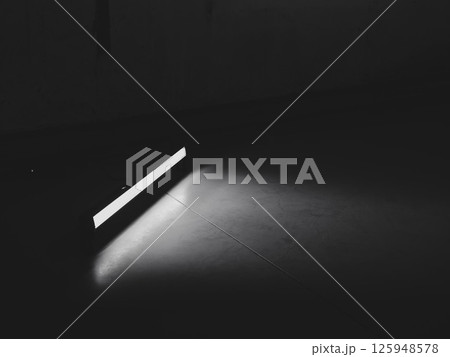 A Minimalist Light Beam Illuminating a Dark Floor in an Abstract and Aesthetic Way A Minimalist Light Beam Illuminating a Dark Floor in an Abstract and Aesthetic Way 125948578