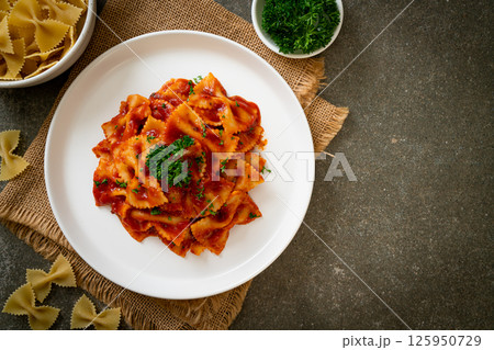 farfalle pasta in tomato sauce with parsley farfalle pasta in tomato sauce with parsley 125950729