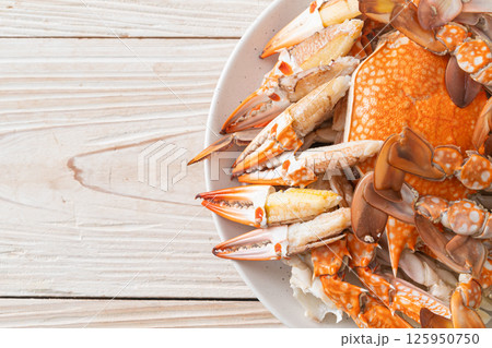 Steamed blue crab with spicy seafood sauce Steamed blue crab with spicy seafood sauce 125950750