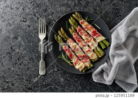 Grilled green asparagus wrapped in bacon. Grilled green asparagus wrapped in bacon. 125951189
