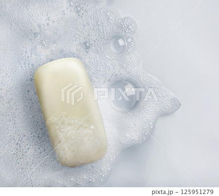 White soap bar and suds on a white background. 125951279