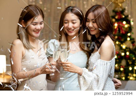 group of 3 friends are toasting cheer at a home party group of 3 friends are toasting cheer at a home party 125952994