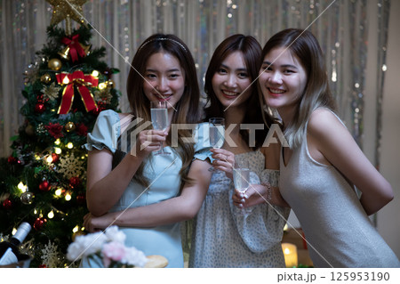 Group of female friends gathered to eat at a party with candles 125953190