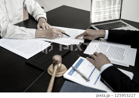 Attorneys and associates or clients are pointing to a document indicating 125953217