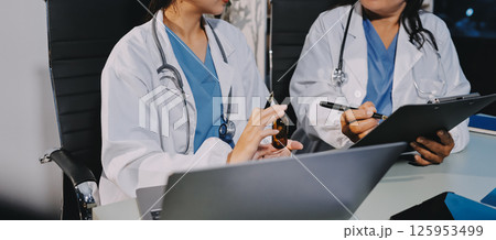Male and female doctors are having a meeting in a hospital room. Male and female doctors are having a meeting in a hospital room. 125953499