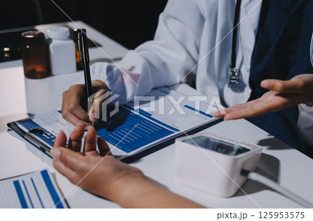 Nurse measuring blood pressure of elderly woman at table, closeup. Assisting senior generation Nurse measuring blood pressure of elderly woman at table, closeup. Assisting senior generation 125953575