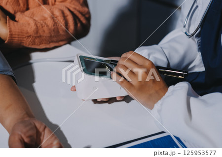 Nurse measuring blood pressure of elderly woman at table, closeup. Assisting senior generation 125953577