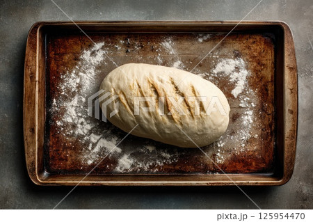 top view of unbaked sourdough bread on a baking tray 125954470