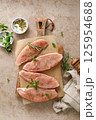 Meat. Raw turkey tenderloin meat, turkey steaks with ingredients for cooking, top view 125954688