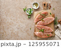Meat. Raw turkey tenderloin meat, turkey steaks with ingredients for cooking, top view 125955071