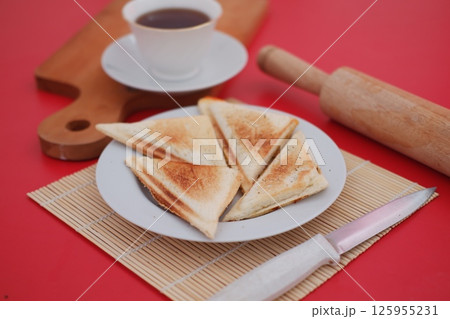 a neatly plated pair of toasted sandwich triangles on a white plate 125955231