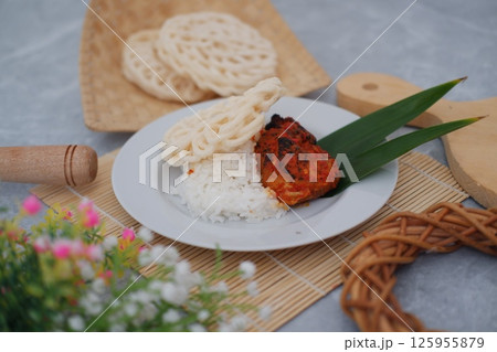 a traditional Indonesian meal served on a white plate a traditional Indonesian meal served on a white plate 125955879