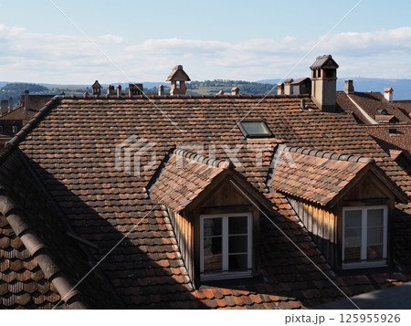 Windows on roof of European Murten town in Switzerland 125955926