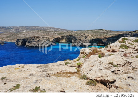 Catamaran and blue lagoon at European Comino island in Malta Catamaran and blue lagoon at European Comino island in Malta 125956528